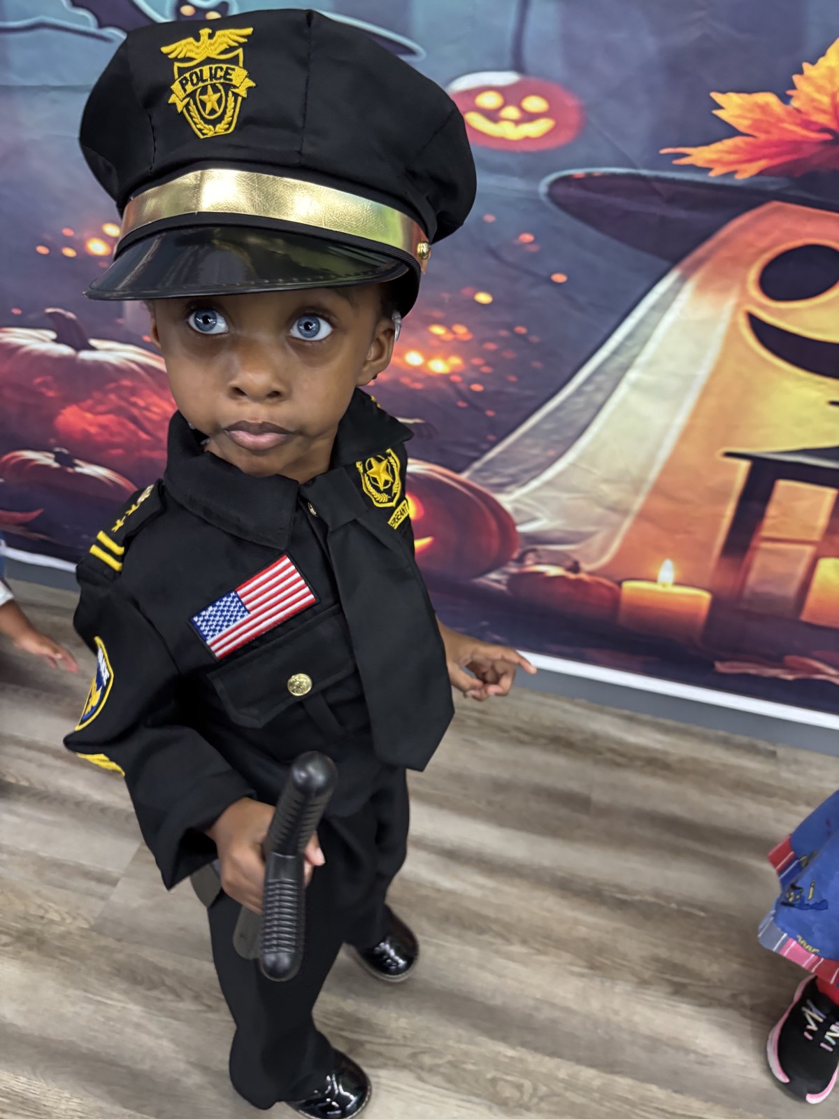 Child dressed as a police officer at Appleseed